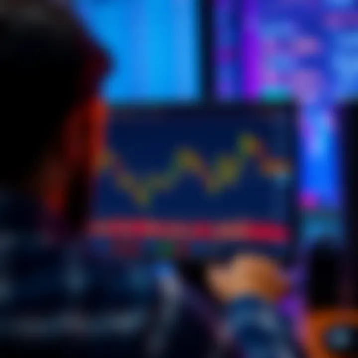 A person looking at a fluctuating Bitcoin chart on a computer screen, showing a decline in value.