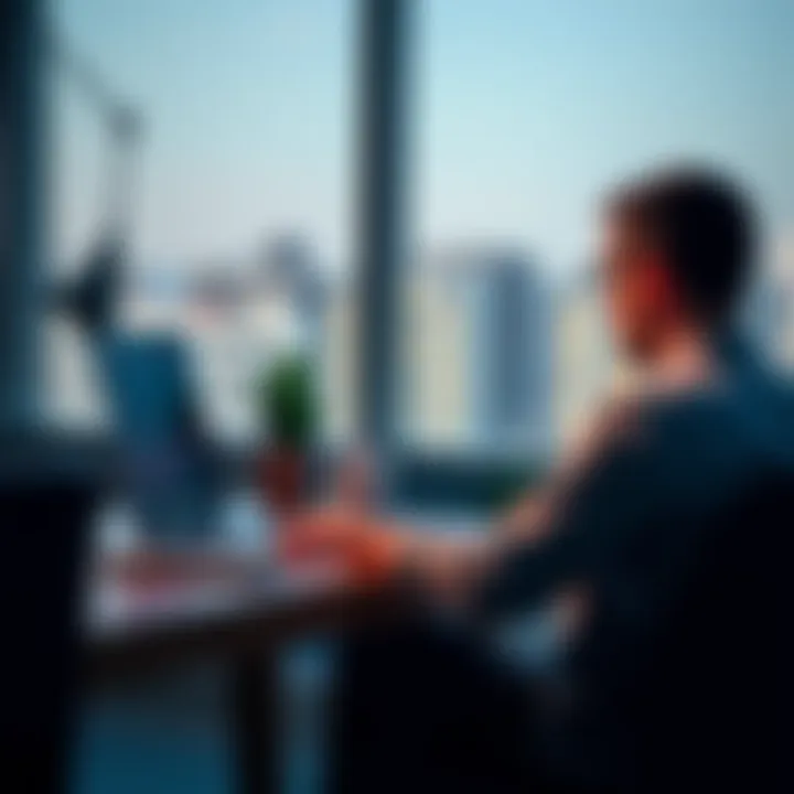 Person closing an account A person sitting at a desk with a laptop, looking focused while navigating a website to close an account.