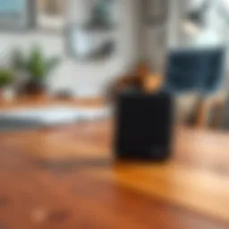 A Trezor Safe 3 hardware wallet sitting on a wooden table with a blurred background of a home office setup. The wallet is sleek and modern, symbolizing digital security for cryptocurrencies.